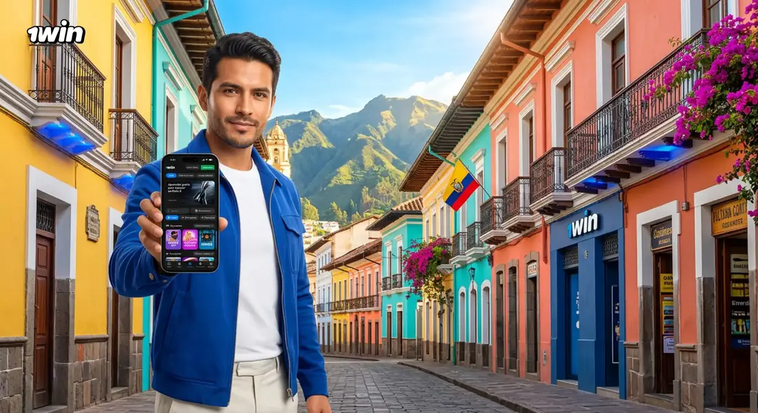 Hombre en una calle colonial de casas de colores en Ecuador que muestra la app de 1win en su celular